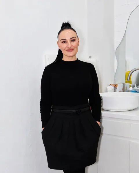 Chrystyl standing in the clinic, dressed in black