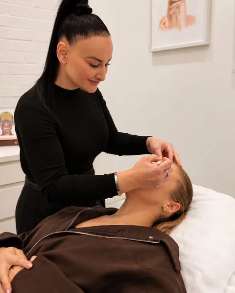 Chrystyl treating a client lying on a treatment bed