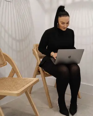 Chrystyl working on a laptop in the clinic