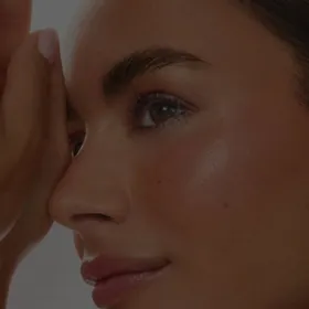 Profile of a woman with her hand resting on her brow