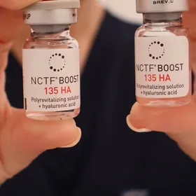Two vials of NCTF Boost 135 HA held up to the camera