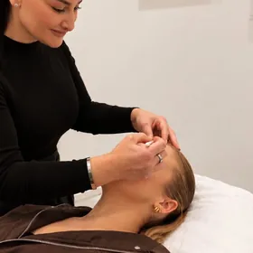 Chrystyl treating a client lying on a treatment bed